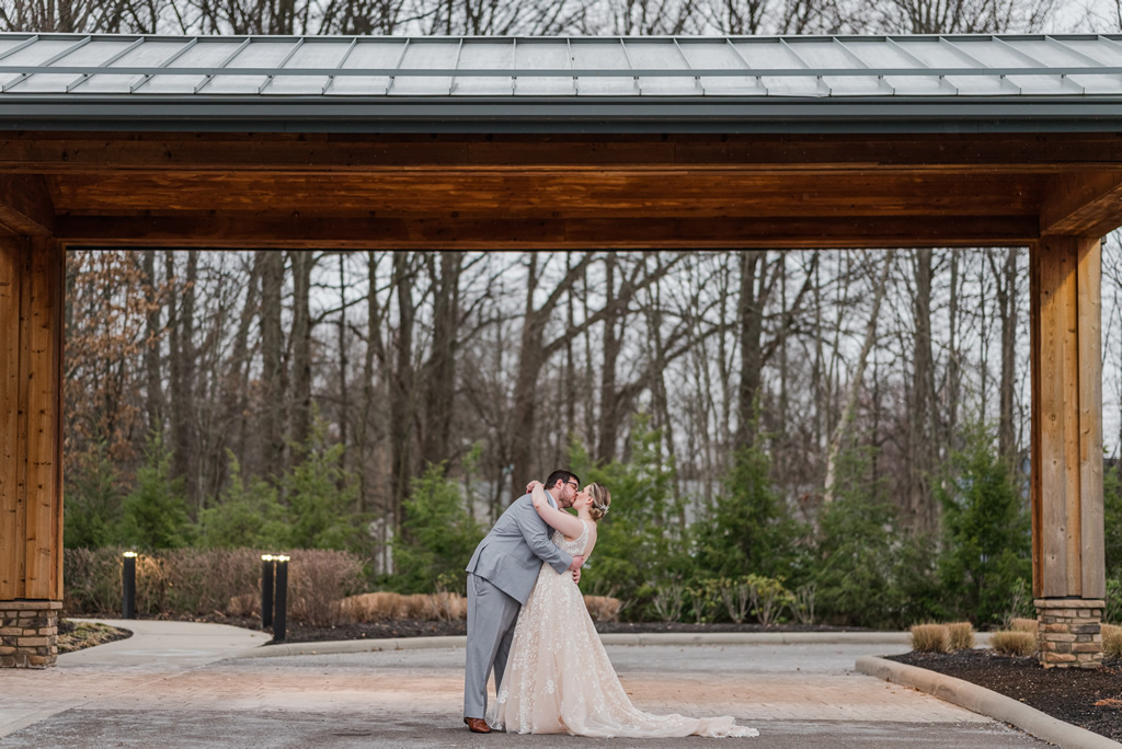 Couple kissing under veranda. Photo by Brittney Cottman Photography.
