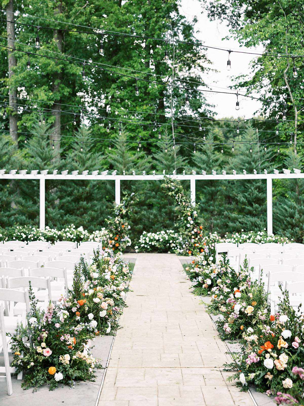 Outside ceremony florals - Photo by Marissa Belle Photography