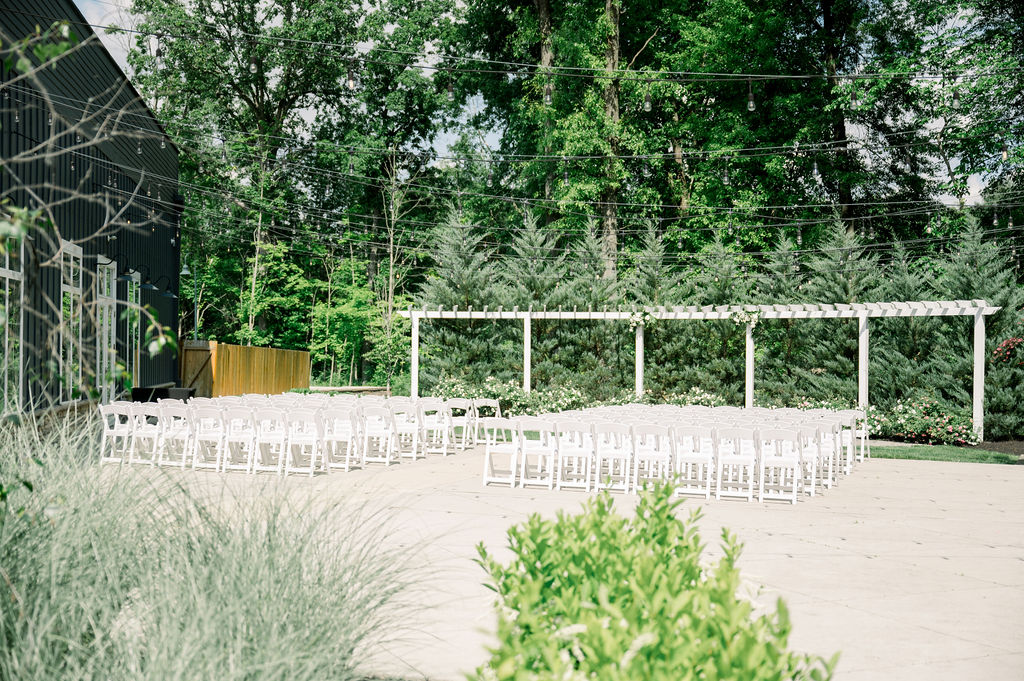 Wedding ceremony setup in outdoor patio space at The Estate