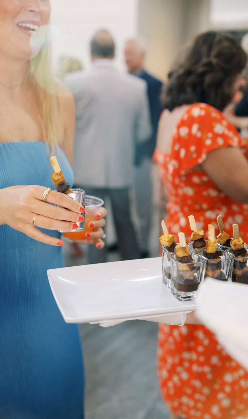 Corporate event guest enjoying passed appetizers served in shot glasses during cocktail hour at The Estate at New Albany.