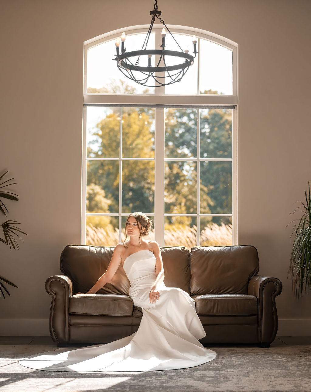 Bride sitting on couch in sunlight