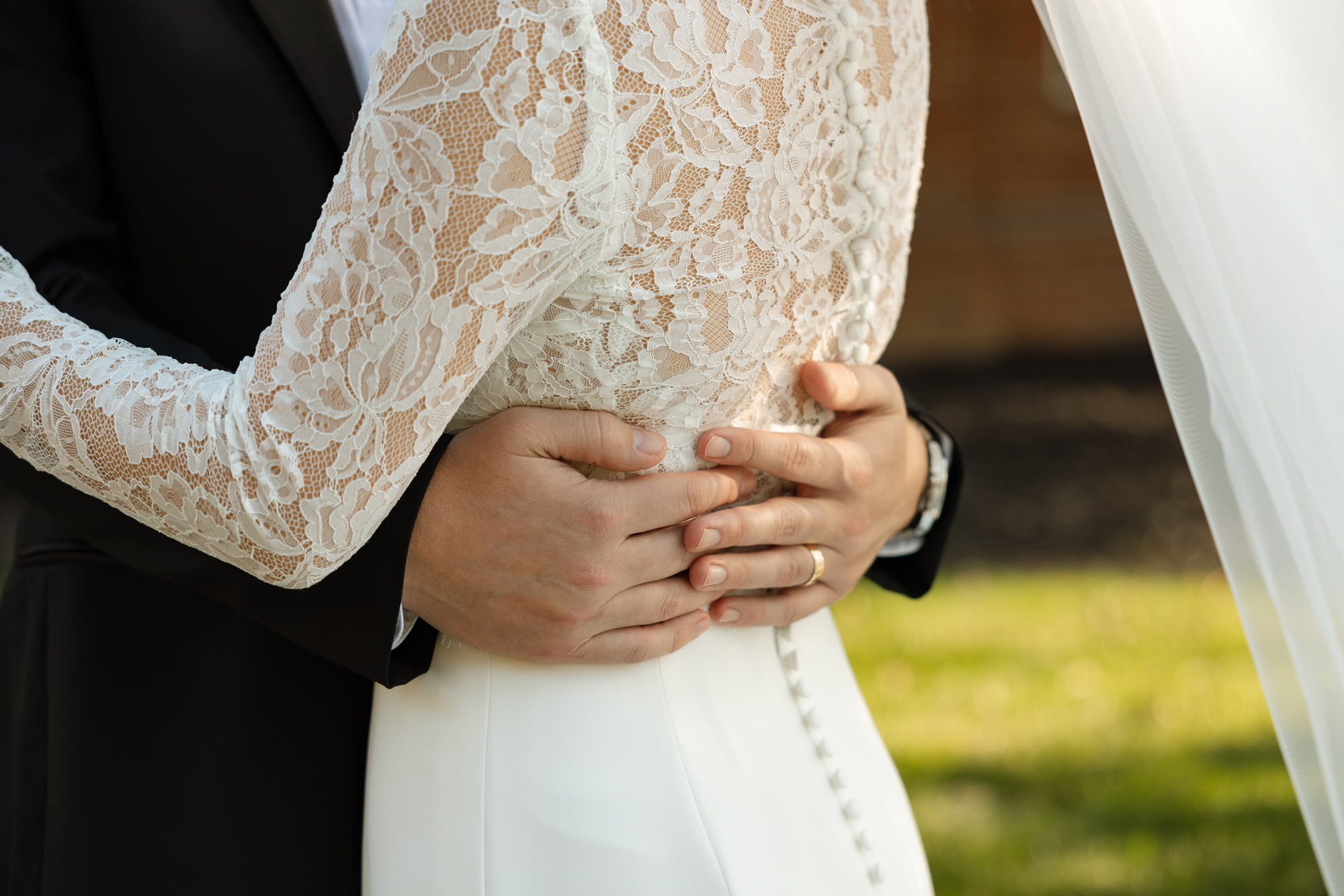 Close-up of bride and groom embracing on wedding day
