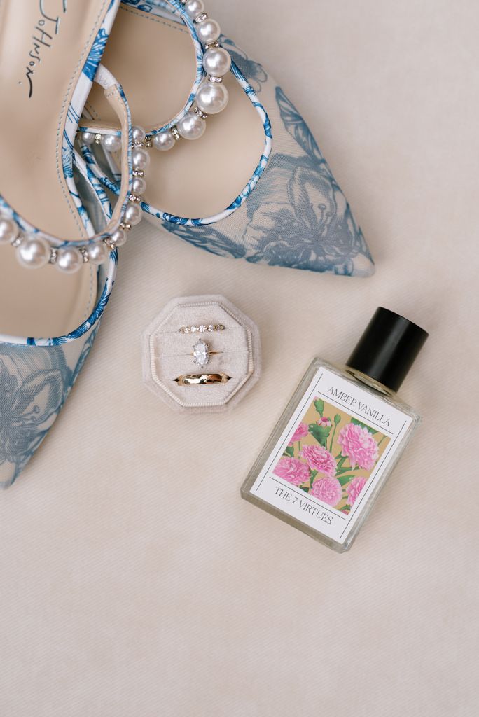 Flat lay with ring, shoes, perfume