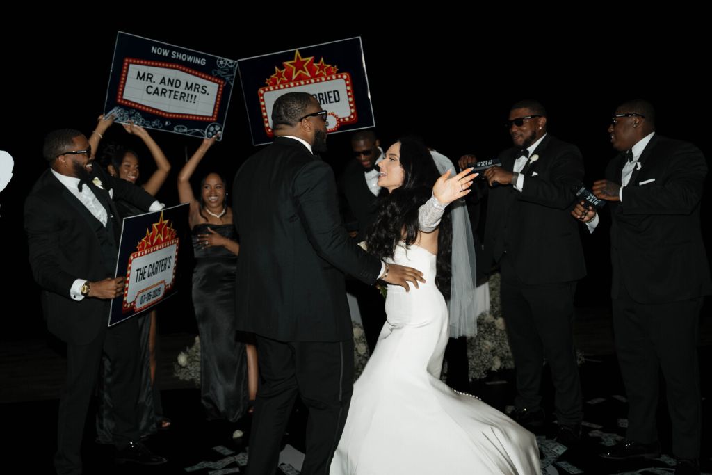 Newlyweds celebrating in front of just married signs, Hollywood wedding style